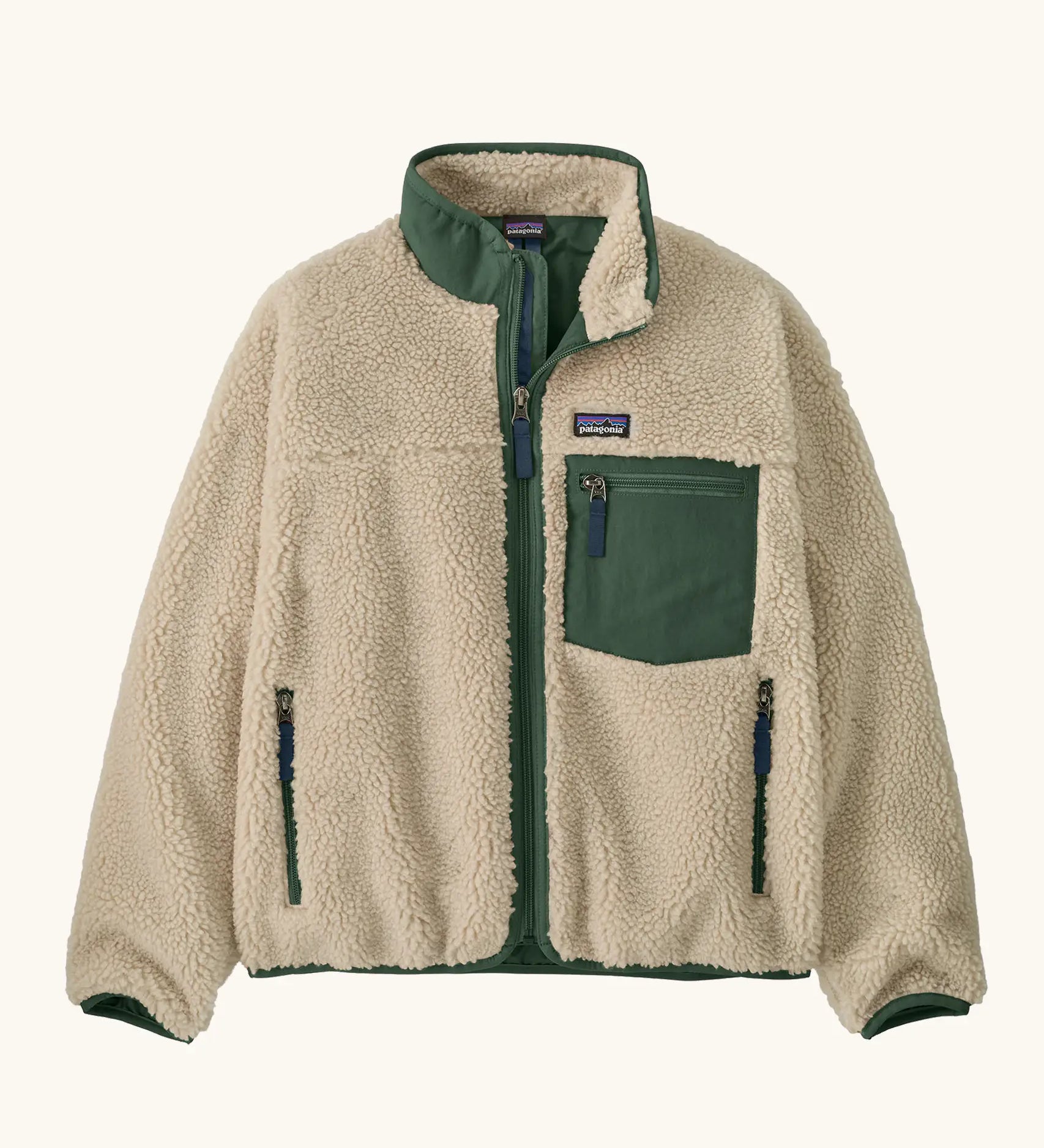 Patagonia Kids Retro X Fleece Jacket in Dark Natural with Canopy Green. Cream fleece with contrasting forest green binding, collar and square chest pocket.
