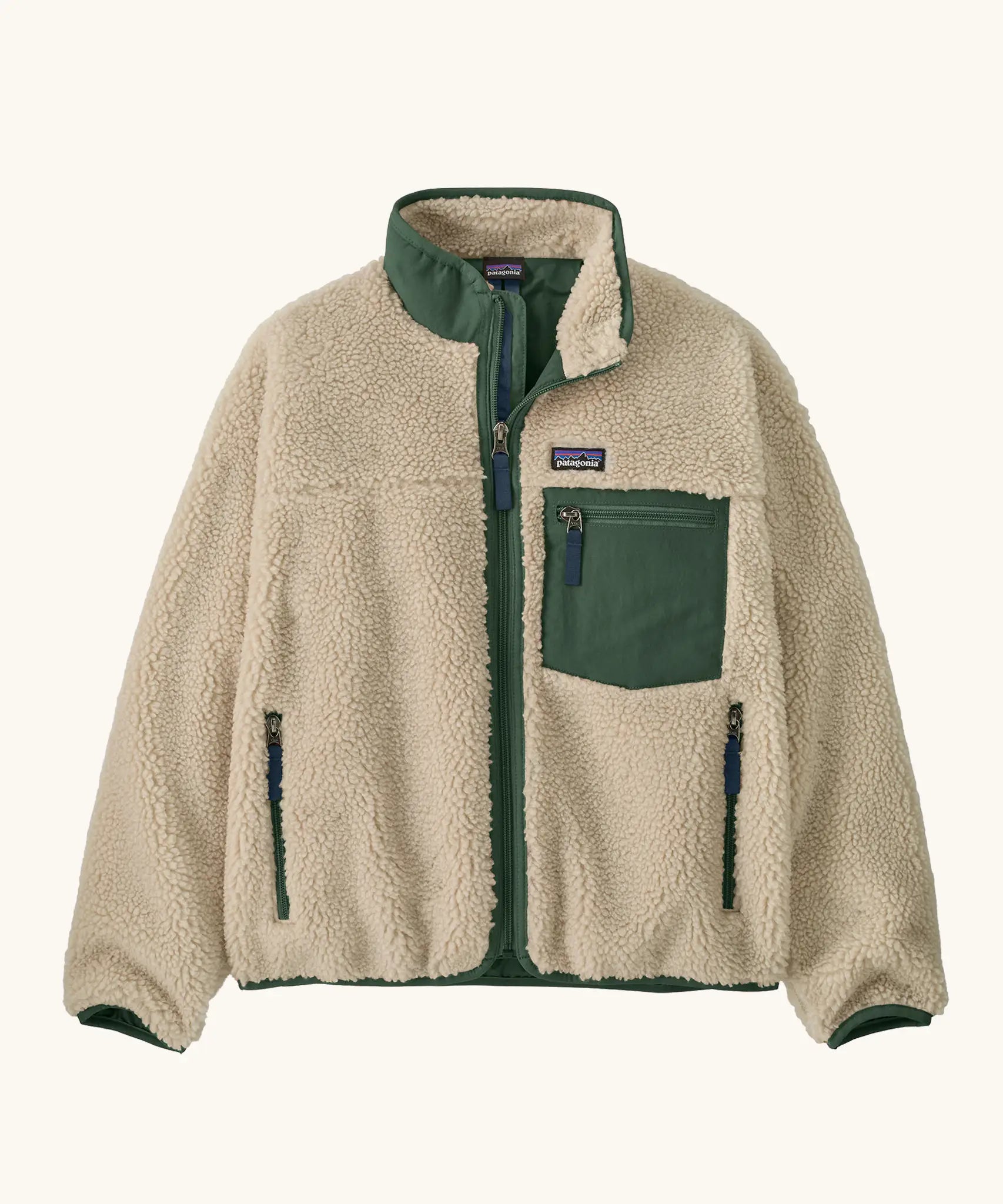 Patagonia Kids Retro X Fleece Jacket in Dark Natural with Canopy Green. Cream fleece with contrasting forest green binding, collar and square chest pocket.