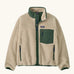 Patagonia Kids Retro X Fleece Jacket in Dark Natural with Canopy Green. Cream fleece with contrasting forest green binding, collar and square chest pocket.