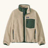 Patagonia Kids Retro X Fleece Jacket in Dark Natural with Canopy Green. Cream fleece with contrasting forest green binding, collar and square chest pocket.