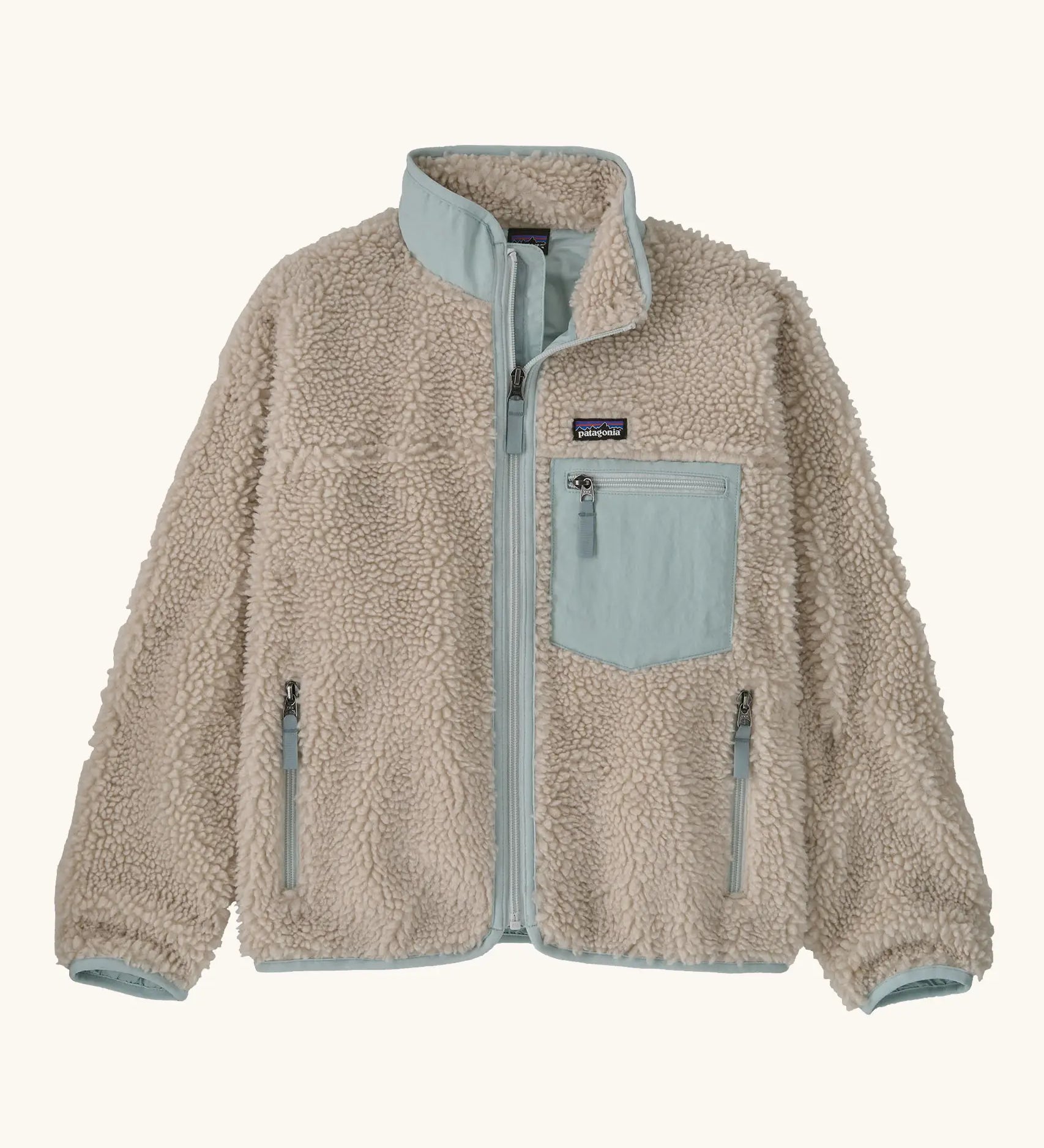 Patagonia Kids Retro X Fleece Jacket in Natural with Virtually blue. Cream fleece with contrasting pale blue binding, collar and square chest pocket.