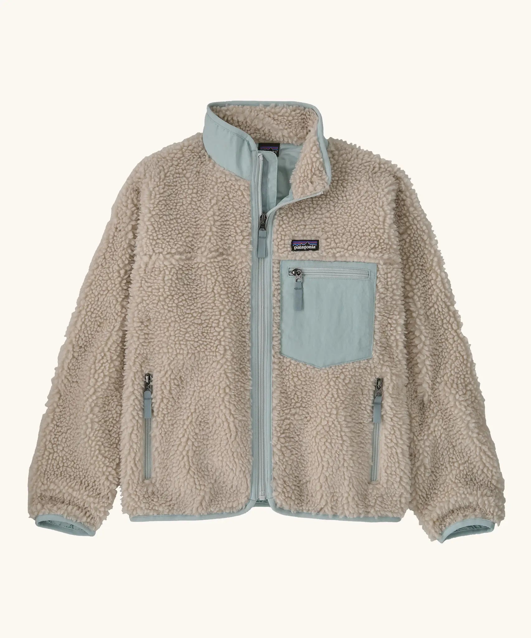 Patagonia Kids Retro X Fleece Jacket in Natural with Virtually blue. Cream fleece with contrasting pale blue binding, collar and square chest pocket.