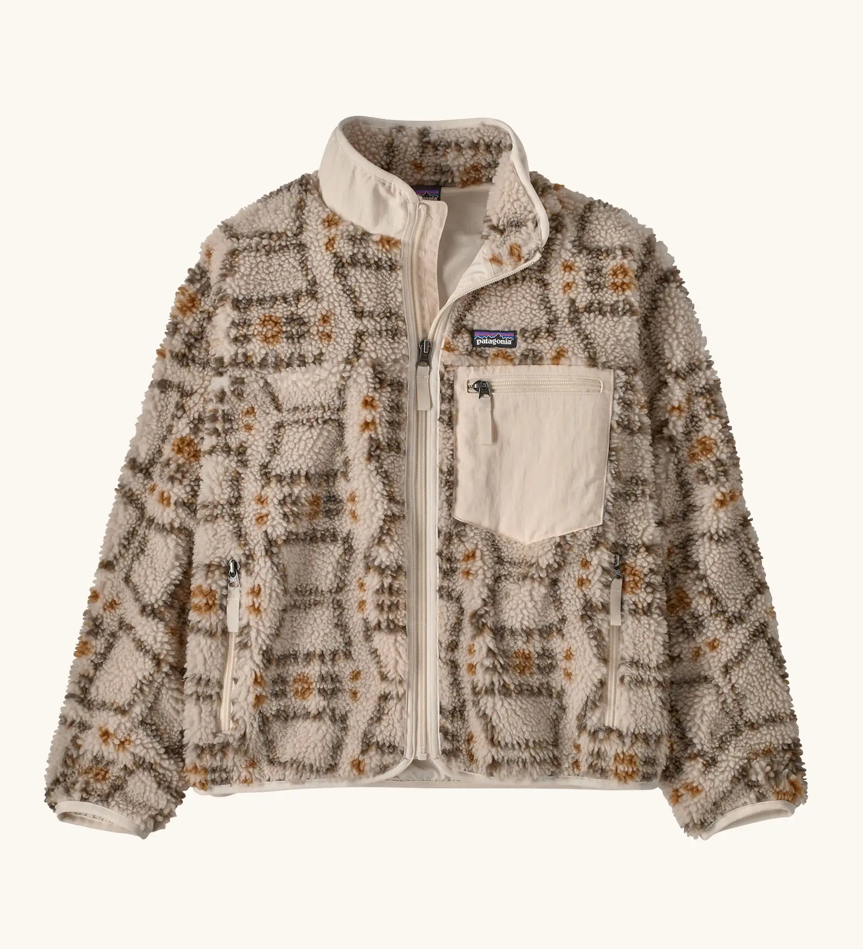 Patagonia Kids Retro X Fleece Jacket in snowshoe Hare, Natural. Cream fleece base with a beige and brown tortoiseshell-style pattern, and a cream square chest pocket.