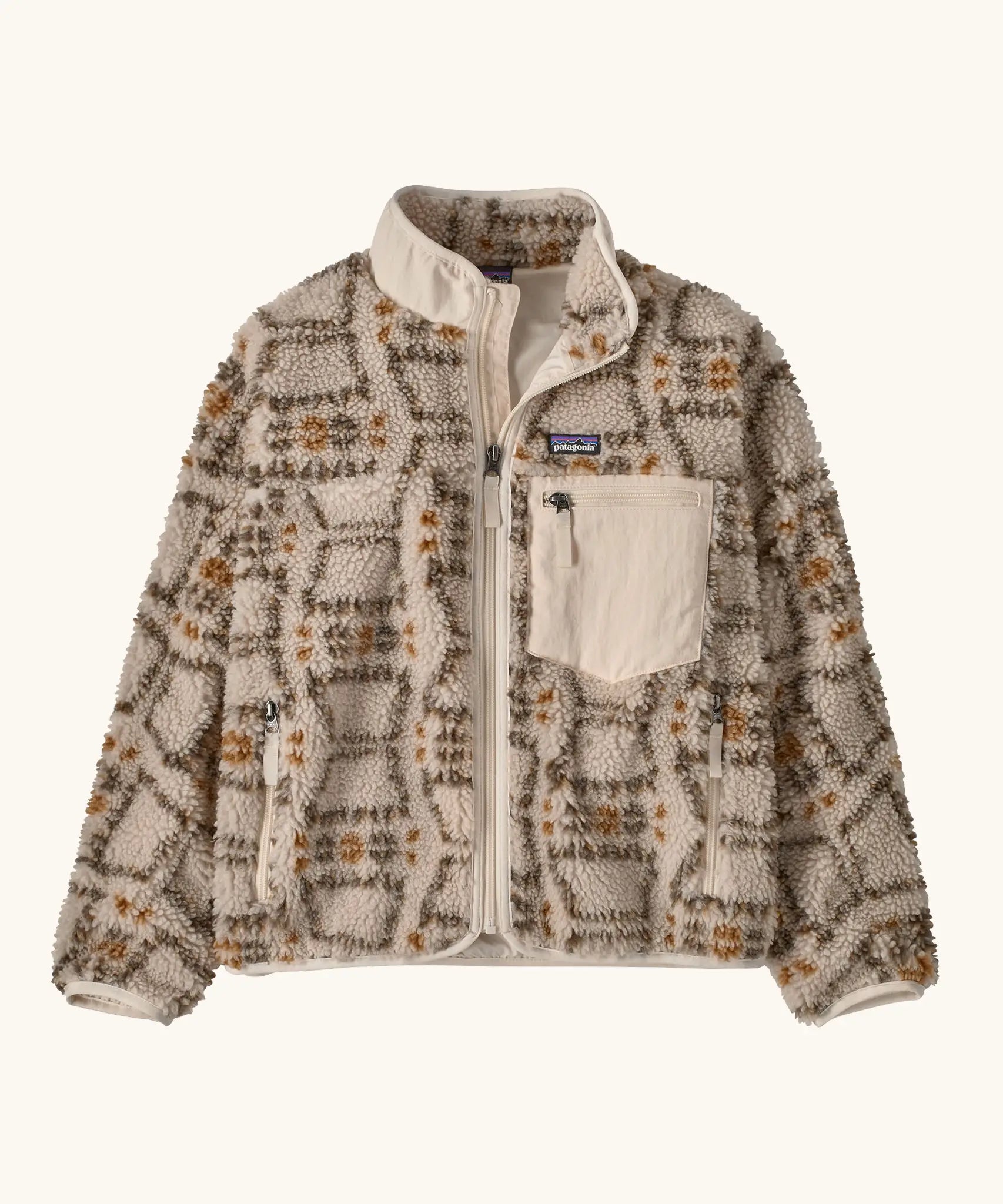 Patagonia Kids Retro X Fleece Jacket in snowshoe Hare, Natural. Cream fleece base with a beige and brown tortoiseshell-style pattern, and a cream square chest pocket.