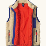 An open Patagonia kids retro x vest in dark natural showing pile fleece outer and bright orange inner lining