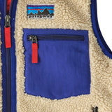 Patagonia kids retro x vest in dark natural showing close up of blue chest pocket with zip fastener