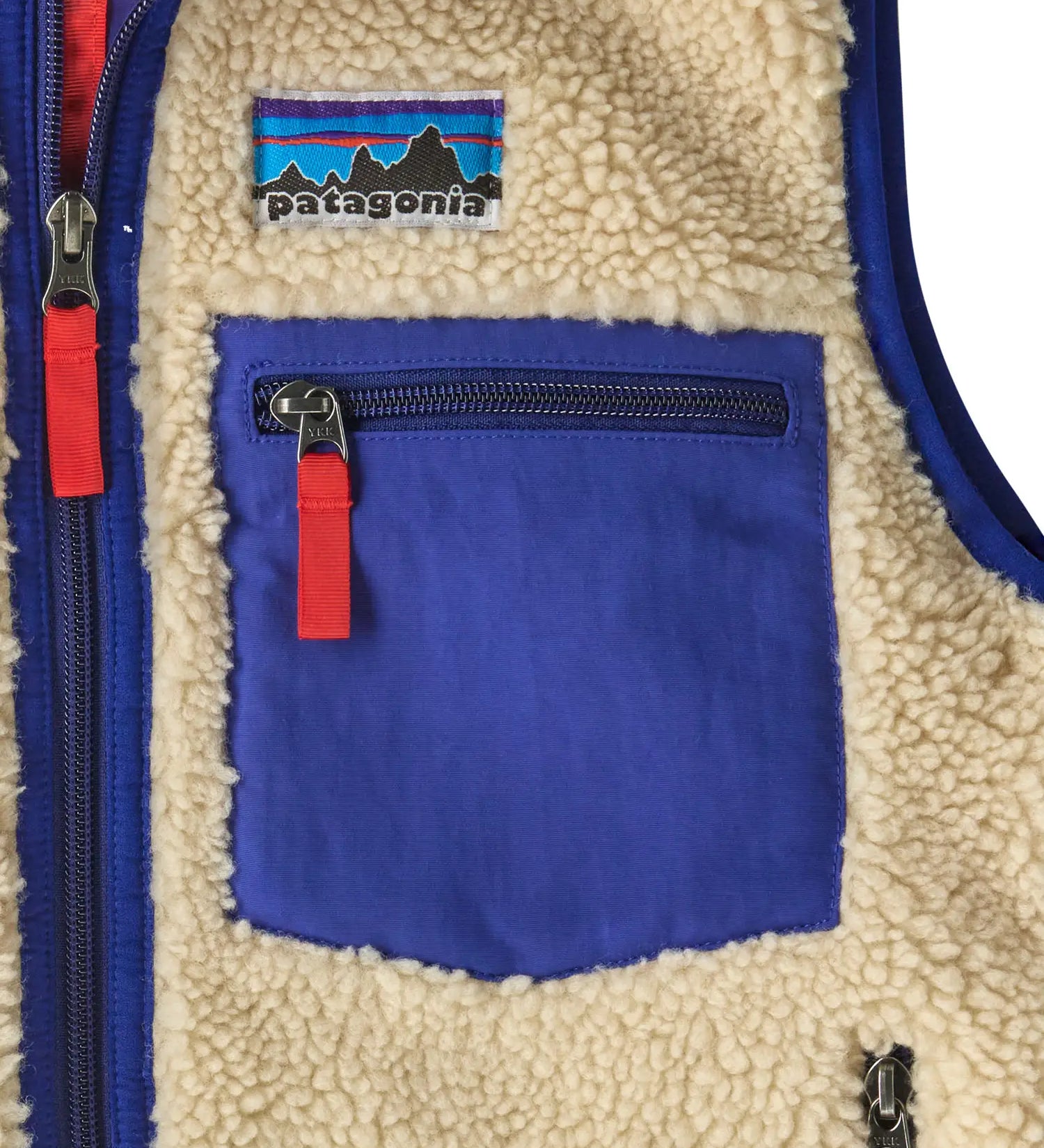 Patagonia kids retro x vest in dark natural showing close up of blue chest pocket with zip fastener
