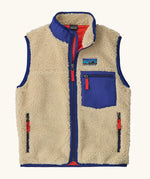 Patagonia kids retro x vest in dark natural. A 100% recycled polyester and pile fleece gilet with dark blue trim. Features a full length zip, 2 side pockets and a small chest pocket