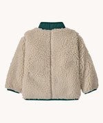 The back of the Patagonia little kids retro x jacket in dark natural/cascade green available at Babipur. A 100% recycled polyester and pile fleece jacket in cream with dark green trim. Features a full length zip, 2 side pockets and a chest pocket.