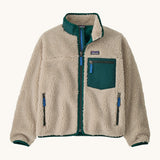 Patagonia kids retro x jacket in dark natural/cascade green available at Babipur.. A 100% recycled polyester thick pile fleece in cream with green trim. Features a turn up collar, full length zip , 2 side pockets and a chest pocket.