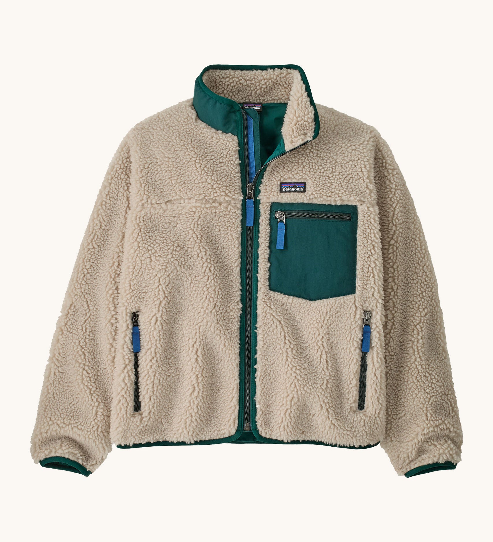 Patagonia kids retro x jacket in dark natural/cascade green available at Babipur.. A 100% recycled polyester thick pile fleece in cream with green trim. Features a turn up collar, full length zip , 2 side pockets and a chest pocket.