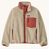 Patagonia kids retro x jacket in dark natural/potters red available at Babipur.. A 100% recycled polyester thick pile fleece in cream with pale red trim. Features a turn up collar, full length zip, 2 side pockets and a chest pocket.