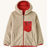 Patagonia Kids Reversible Ready Freddy Hoody in the Amanita red colour way. The kids coat is shown with the off white, cream coloured high pile fleece on the outside.  We're proud stockists of Patagonia here at Babipur.