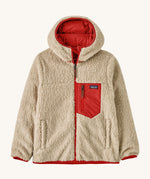 Patagonia Kids Reversible Ready Freddy Hoody in the Amanita red colour way. The kids coat is shown with the off white, cream coloured high pile fleece on the outside.  We're proud stockists of Patagonia here at Babipur.