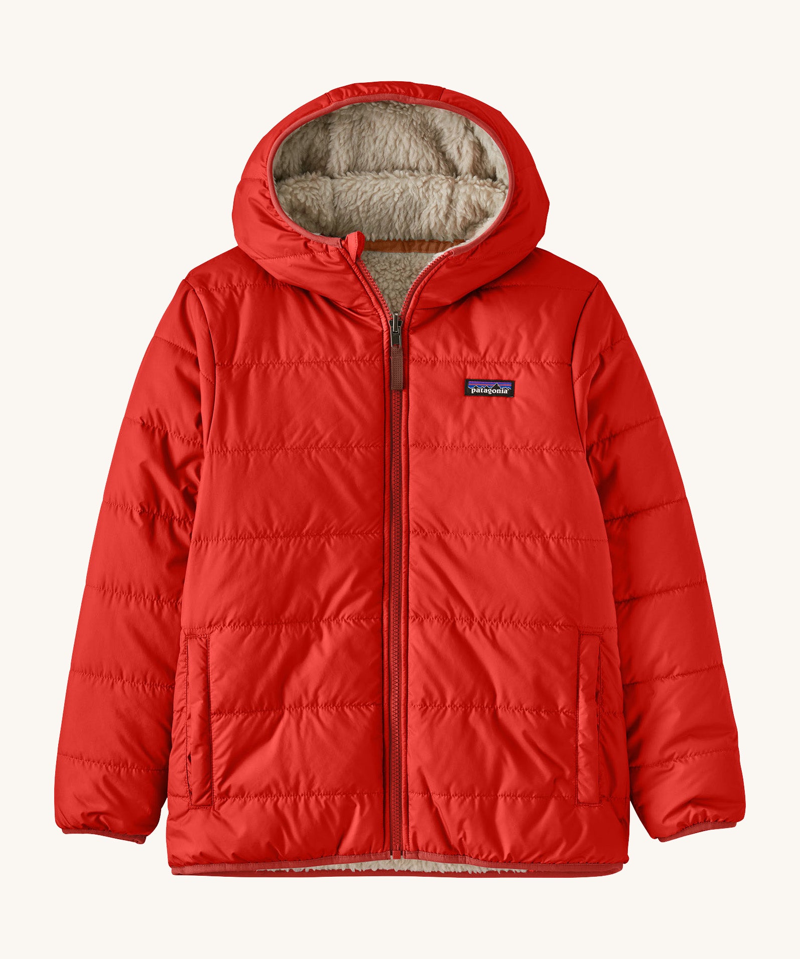 Patagonia Kids Reversible Ready Freddy Hoody in the Amanita red colour way. The kids coat is shown with the red water resistant shell on the outside.  We're proud stockists of Patagonia here at Babipur.