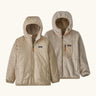 Patagonia kids reversible ready freddy hoody in light tan showing a beige fleece on the reverse. Features a front zip, side and chest pockets