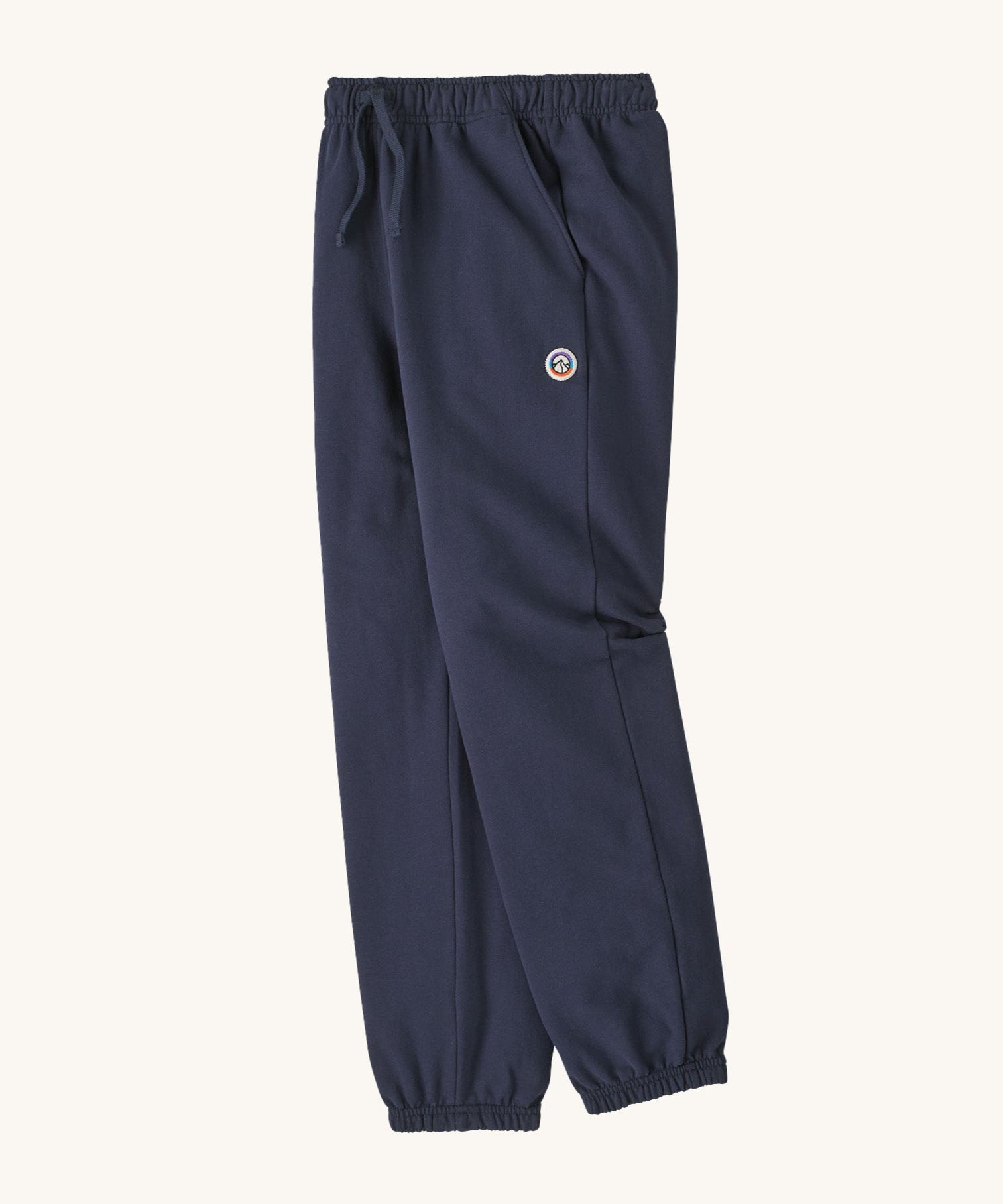 A side image of the Patagonia Kids Sweatpants in a Fitz Roy Icon New Navy colour way available at Babipur. 