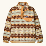 Patagonia Kids Lightweight Synchilla Snap-T Fleece Pullover in Diamond Stripe: Flurry Green. Cream, beige, and brown geometric stripe design with an orange snap placket and matching orange chest pocket flap.