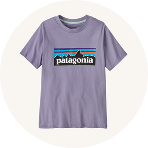 Patagonia purple top on cream background to represent Patagonia kids tops at Babipur.
