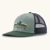 Patagonia Kids Trucker hat in Cover Green. Organic sage green front crown with retro style Patagonia Fitz Roy Foothills logo, Forest green brim, and grey recycled polyester mesh back. 