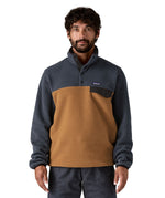 A man wearing the Patagonia mens synchilla deer brown jacket available at Babipur. A lightweight fleece in dark blue and brown colour. Features a chest pocket, logo patch stitched above and a 1/4 length popper fastener.