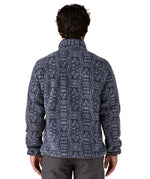 A man wearing and showing the back of the Patagonia mens synchilla jacket available at Babipur
