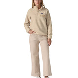 A woman wearing the Patagonia women's synchilla jacket in flow dyno white available at Babipur. 