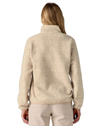 The back of a woman wearing the Patagonia women's synchilla jacket in flow dyno white available at Babipur. 