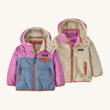 Patagonia little kids tribbles hoody. A reversible coat showing a blue and green hooded coat and natural fleece alternative side. Features a small chest pocket and side pockets