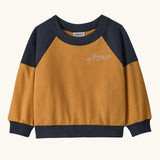Patagonia 100% organic cotton little kids crew sweatshirt in mustard yellow with navy shoulder panels and brand embroidery on the chest