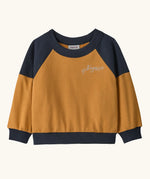 Patagonia 100% organic cotton little kids crew sweatshirt in mustard yellow with navy shoulder panels and brand embroidery on the chest