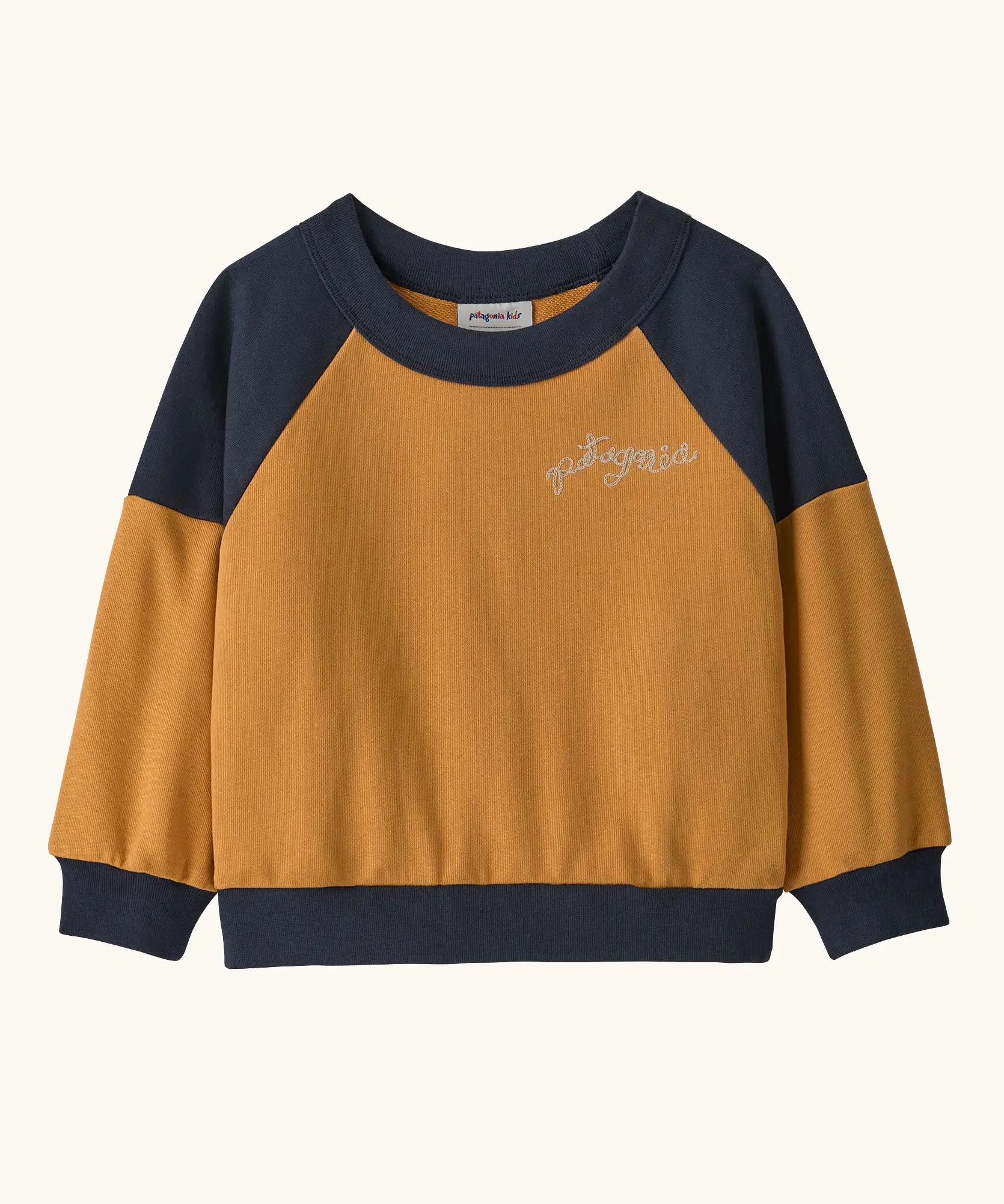 Patagonia 100% organic cotton little kids crew sweatshirt in mustard yellow with navy shoulder panels and brand embroidery on the chest
