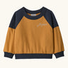 Patagonia 100% organic cotton little kids crew sweatshirt in mustard yellow with navy shoulder panels and brand embroidery on the chest