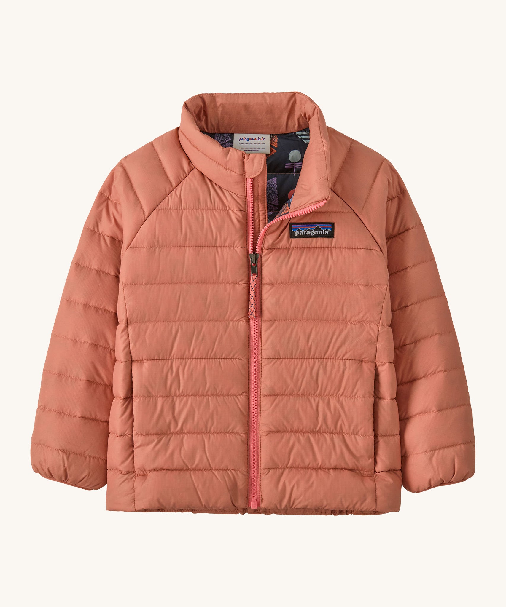 Patagonia little kids down sweater in moment pink. A 100% recycled down jacket in pale pink. Features a padded collar and full length zip