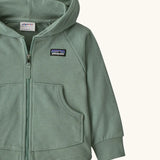 Patagonia 100% organic cotton little kids full zip hoody in pale green showing close up of the pouch pocket on the front