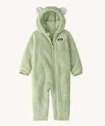 Patagonia little kids furry fiends bunting suit in lichen green available at Babipur. A 100% recycled polyester thick fleece all in one in pastel green with white bear like ears on the hood. Features a full length zip  , elasticated cuffs and a small chest pocket