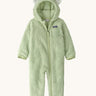 Patagonia little kids furry fiends bunting suit in lichen green available at Babipur. A 100% recycled polyester thick fleece all in one in pastel green with white bear like ears on the hood. Features a full length zip  , elasticated cuffs and a small chest pocket