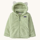 Patagonia little kids furry friends hoody in lichen green available at Babipur. A 100% recycled polyester thick fleece hooded jacket in pale green with white bear like ears on the hood. Features a full length zip and 2 side pockets.