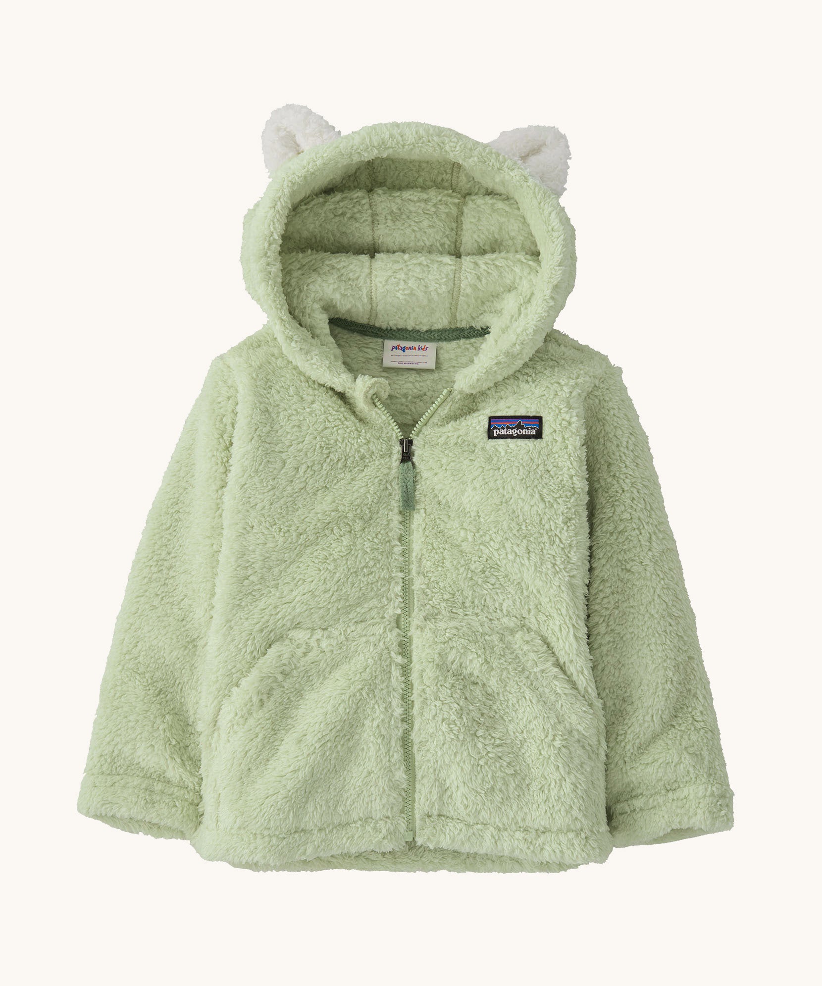 Patagonia little kids furry friends hoody in lichen green available at Babipur. A 100% recycled polyester thick fleece hooded jacket in pale green with white bear like ears on the hood. Features a full length zip and 2 side pockets.