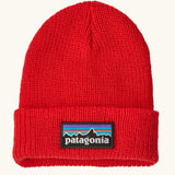 Patagonia little kids knitted beanie in sizzle red with brand patch on brim. Made from 100% recycled polyester yarn