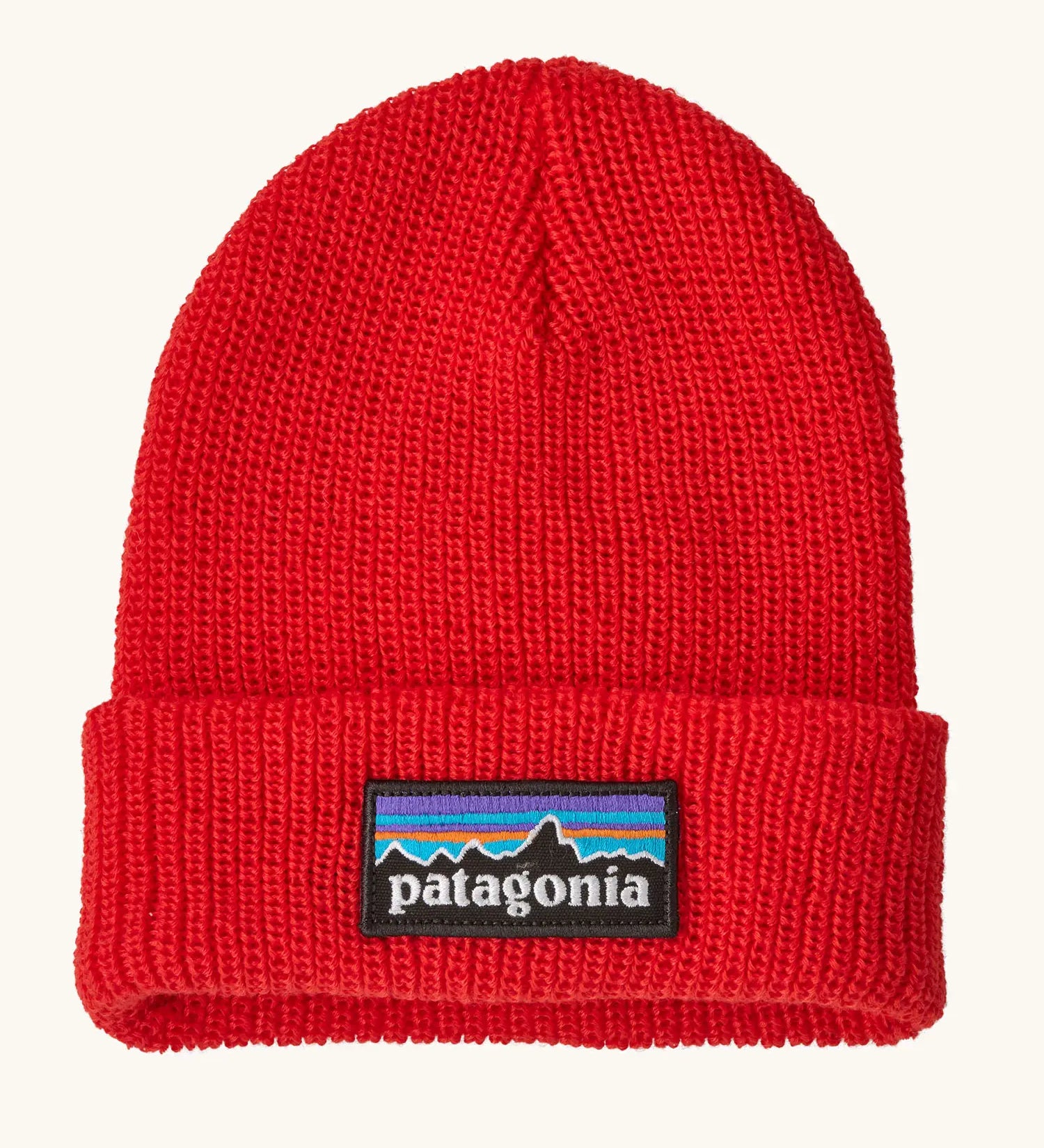 Patagonia little kids knitted beanie in sizzle red with brand patch on brim. Made from 100% recycled polyester yarn