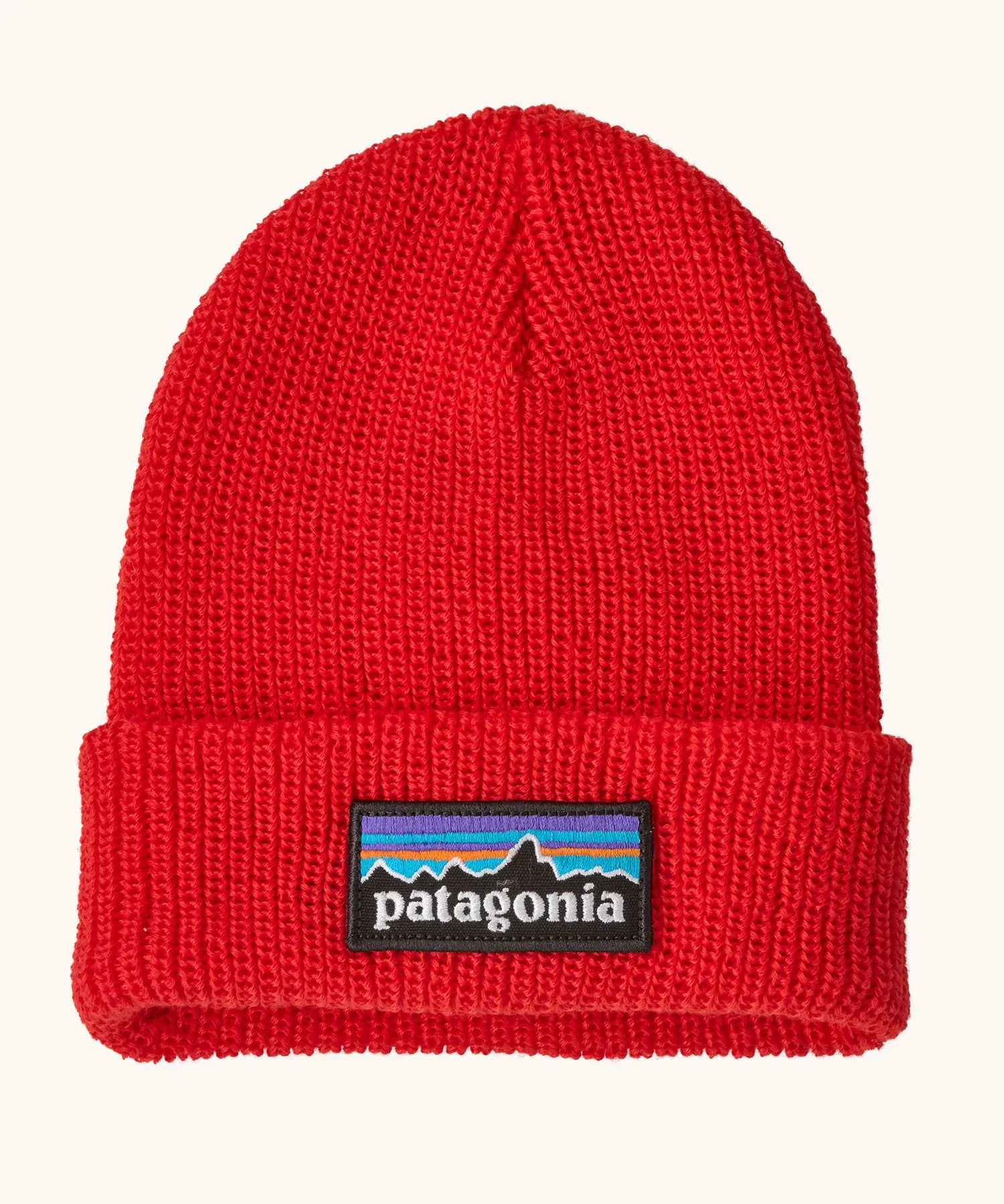 Patagonia little kids knitted beanie in sizzle red with brand patch on brim. Made from 100% recycled polyester yarn