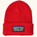 Patagonia little kids knitted beanie in sizzle red with brand patch on brim. Made from 100% recycled polyester yarn