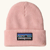 Patagonia little kids knitted beanie in sunlit pink with brand patch on brim. Made from 100% recycled polyester yarn