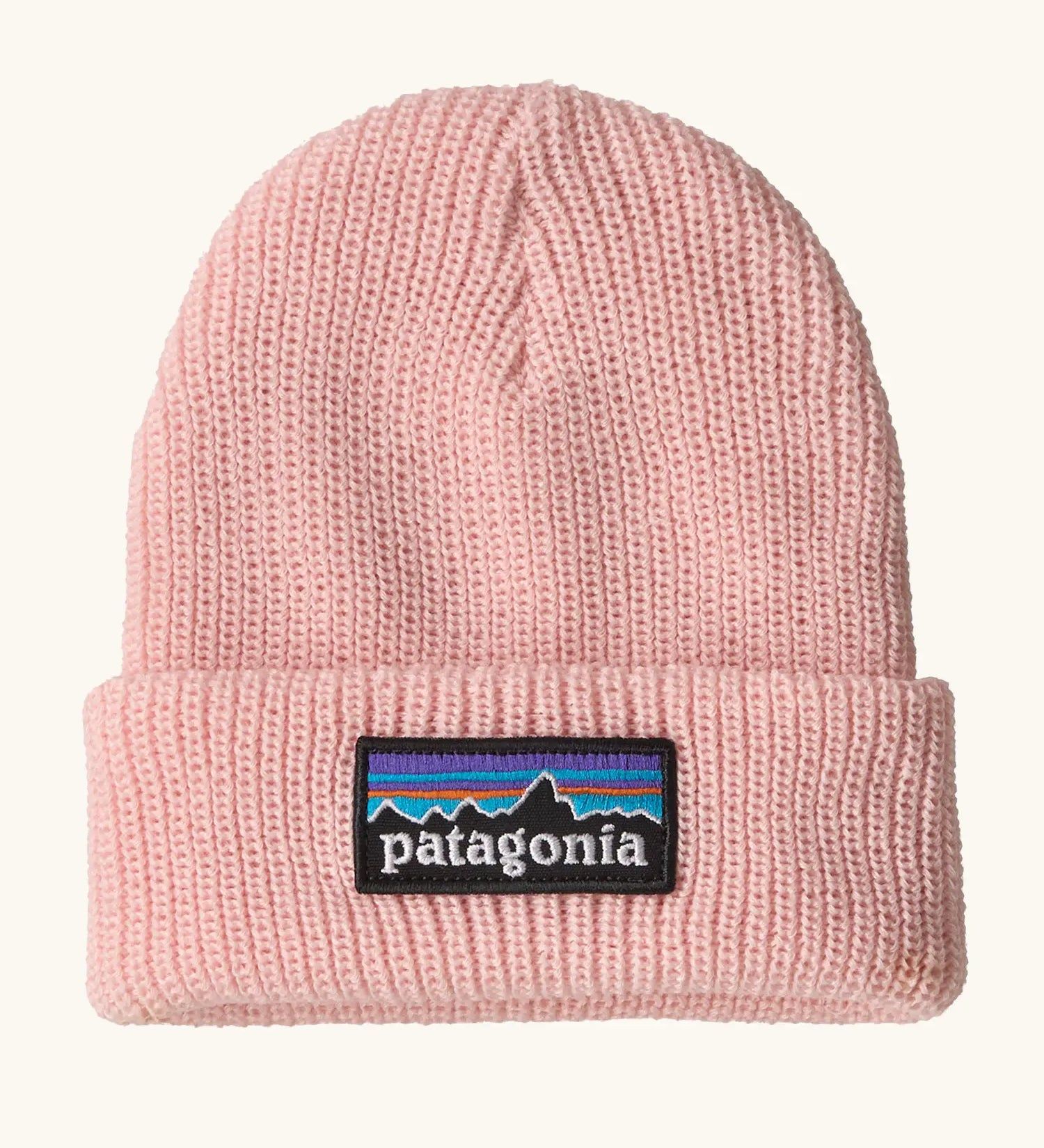 Patagonia little kids knitted beanie in sunlit pink with brand patch on brim. Made from 100% recycled polyester yarn