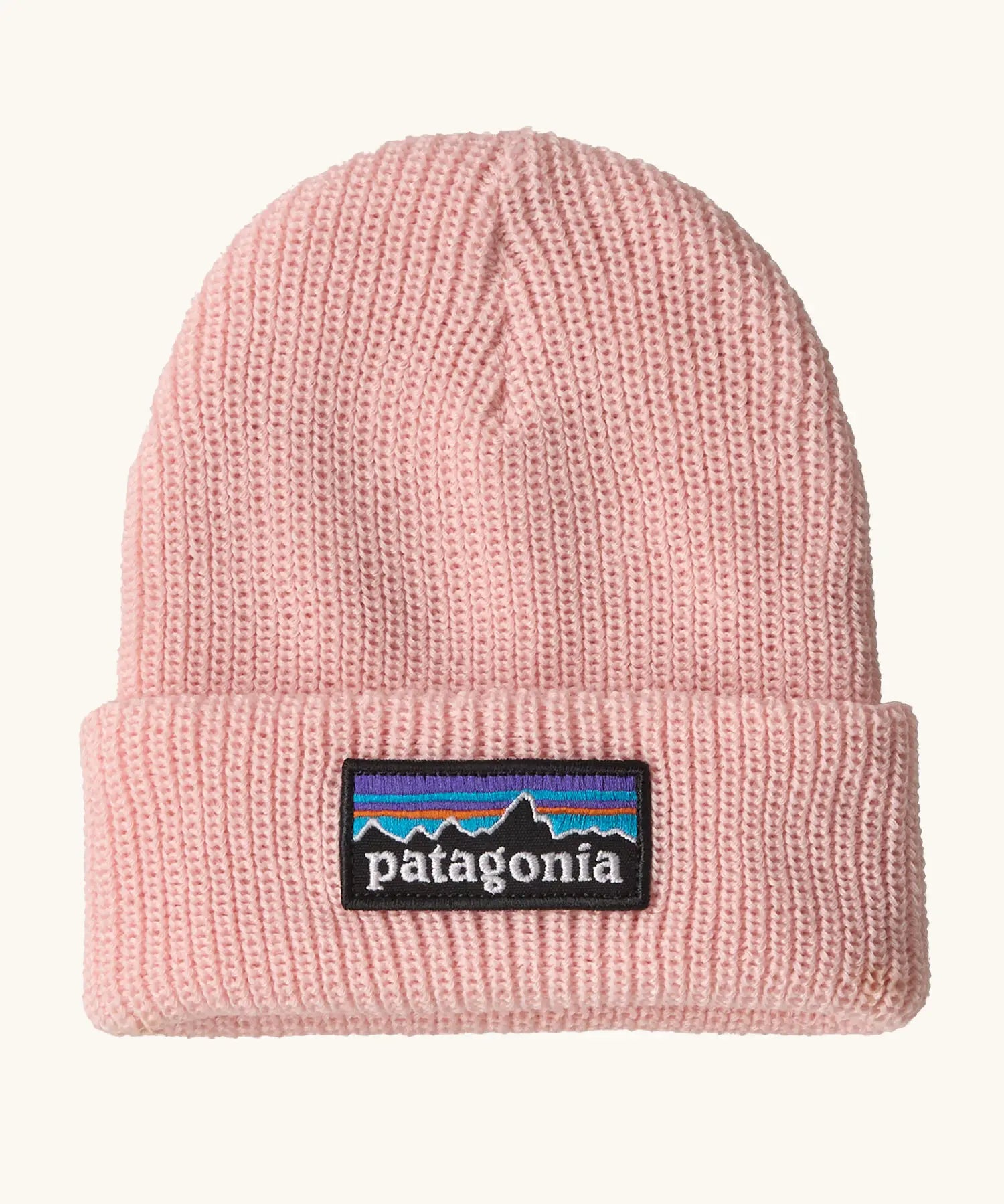Patagonia little kids knitted beanie in sunlit pink with brand patch on brim. Made from 100% recycled polyester yarn