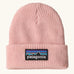Patagonia little kids knitted beanie in sunlit pink with brand patch on brim. Made from 100% recycled polyester yarn