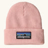 Patagonia little kids knitted beanie in sunlit pink with brand patch on brim. Made from 100% recycled polyester yarn