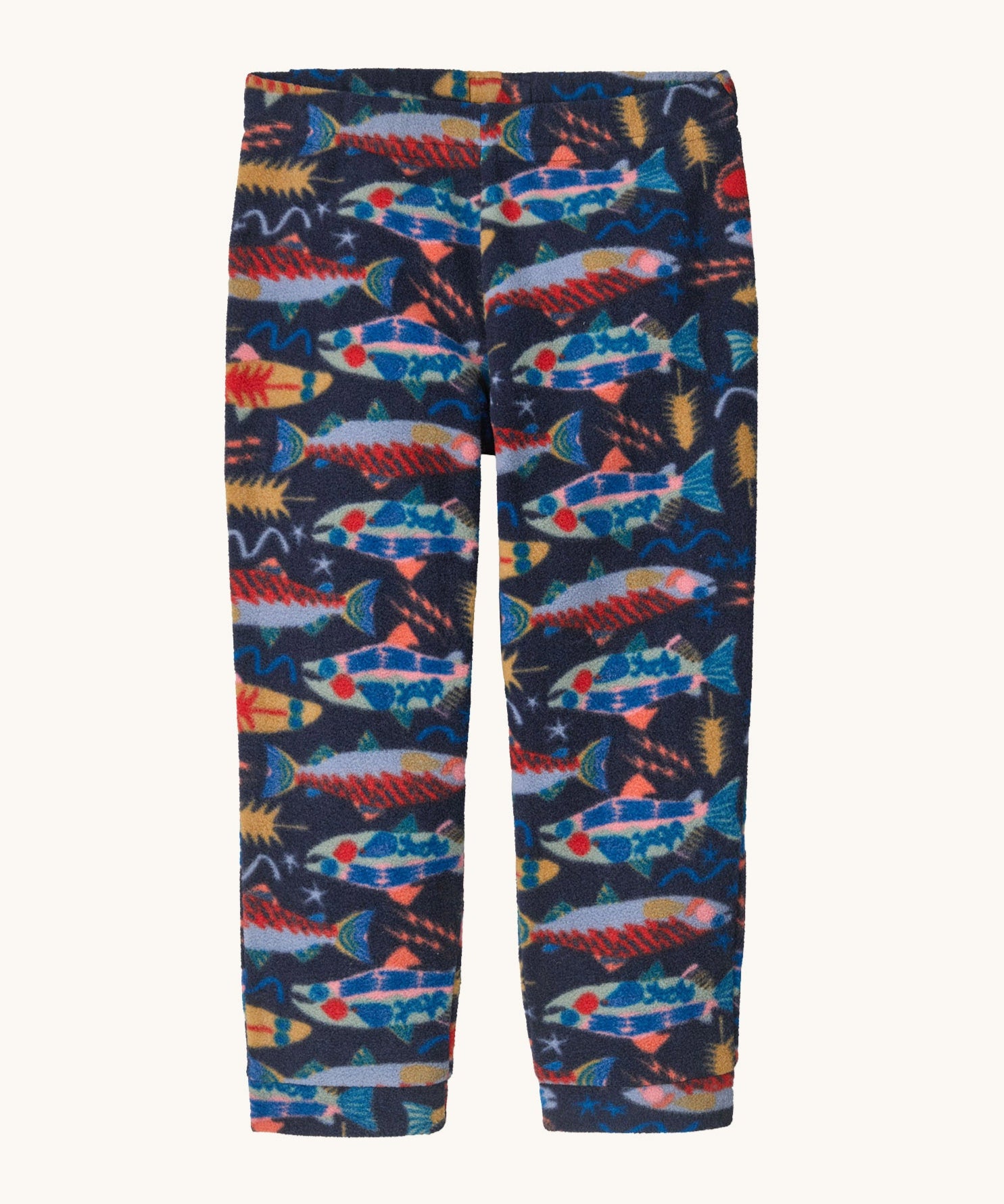 Patagonia little kids micro d bottoms in salmon energy/new navy. A 100% recycled polyester soft fleece style trousers in navy with a funky multicoloured fish design