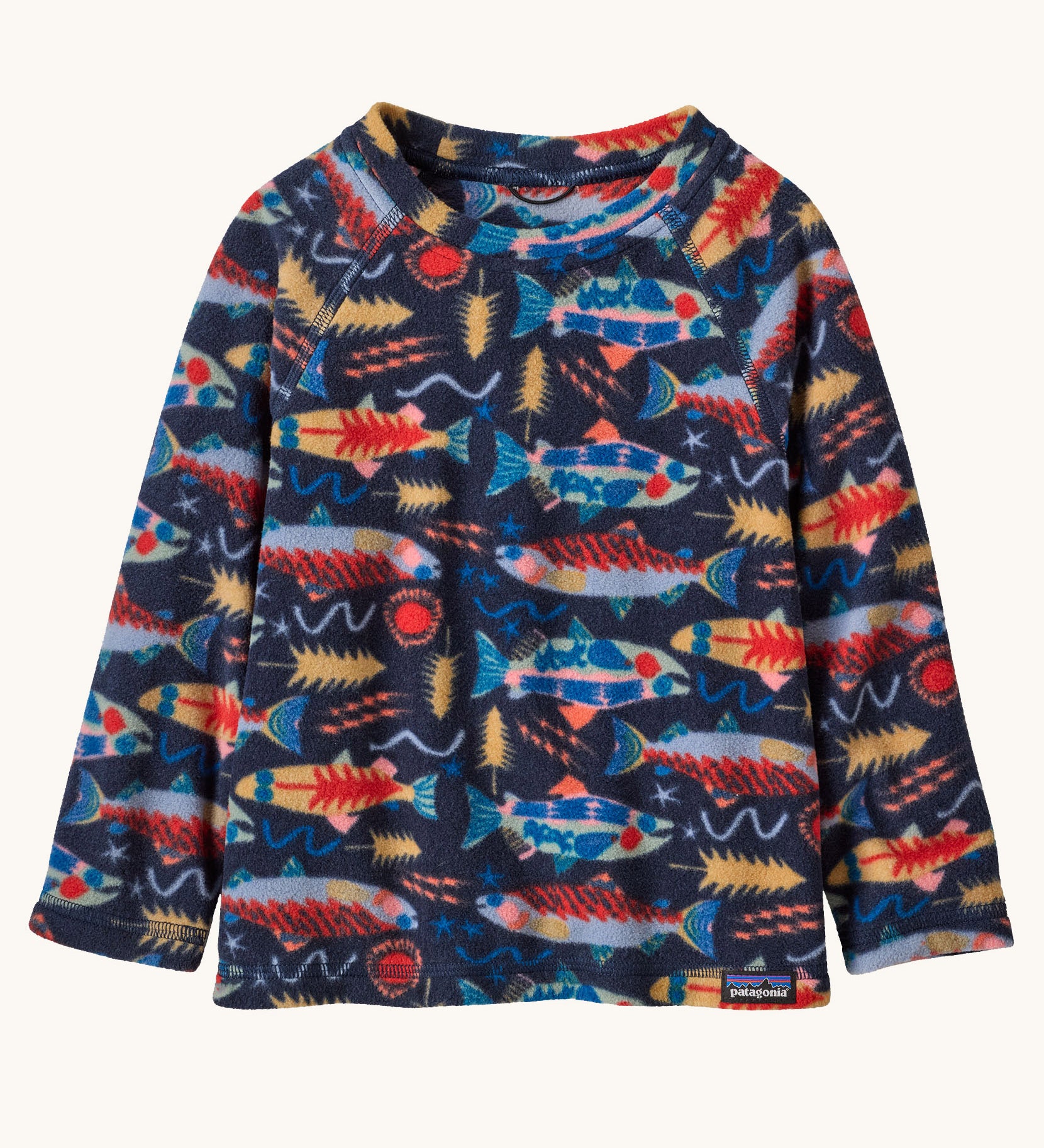 Patagonia kittle kids micro d crew jumper in salmon energy/new navy available at Babipur. A 100% recycled polyester soft fleece jumper in navy with a funky multicoloured fish pattern design 